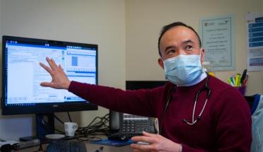 Doctor Kean-Seng Lim sitting at computer