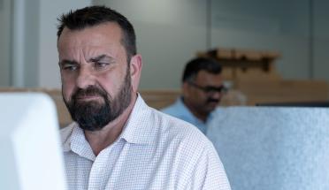 A man works on a computer.