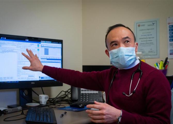 Doctor Kean-Seng Lim sitting at computer