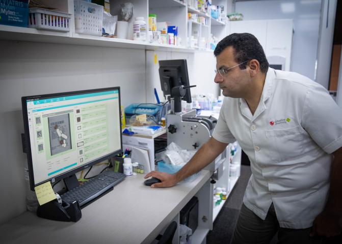 Pharmacist looking at medicine information on a computer