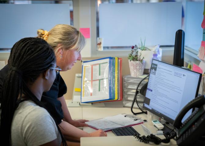 Two people looking at a monitor