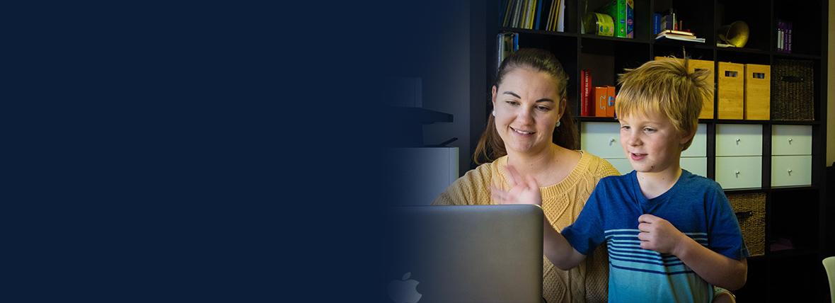 Woman and child looking at desktop monitor