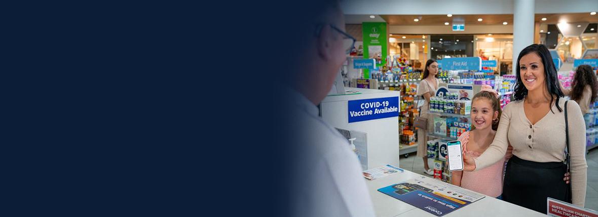 Woman and child showing their phone to a pharmacist