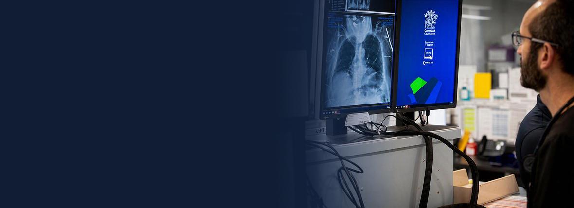 Healthcare provider looking at a scan on a monitor