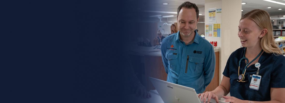 Two healthcare providers looking at laptop