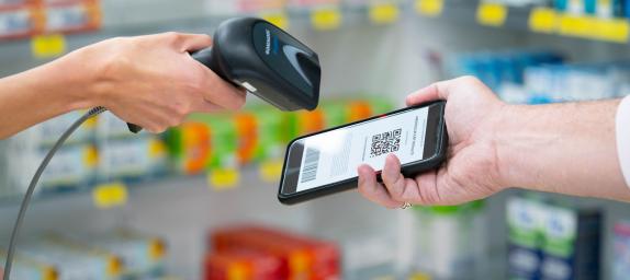 Dispenser scanning a token on a smart phone 