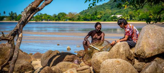 Photo: two men on the rocks by the beach