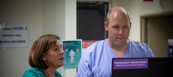 Two hospital staff looking at a monitor