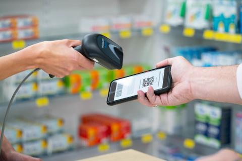Dispenser scanning a token on a smart phone