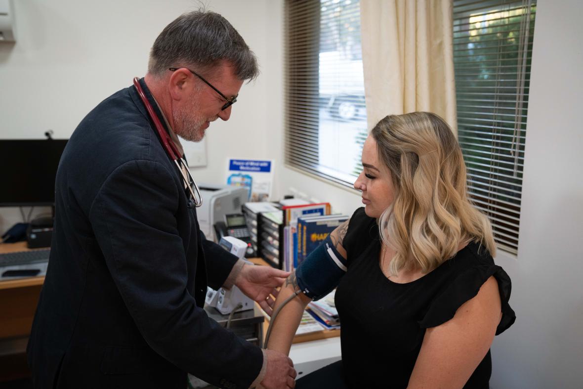 Photo: general practitioner taking a patient's blood pressure