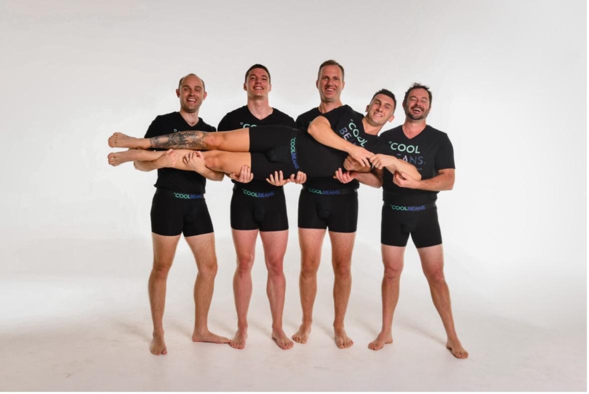 Four men lifting a man, all wearing Cool Beans Underwear.