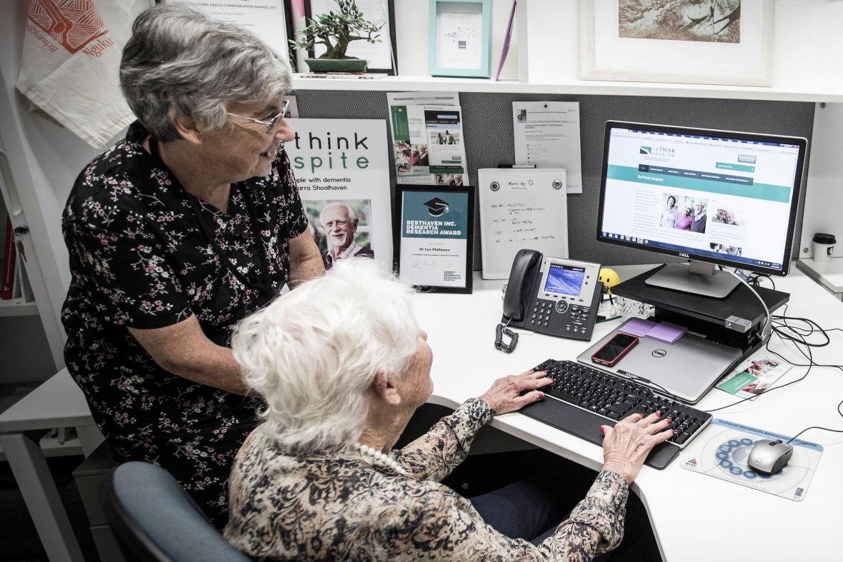 Two people sitting at the computer