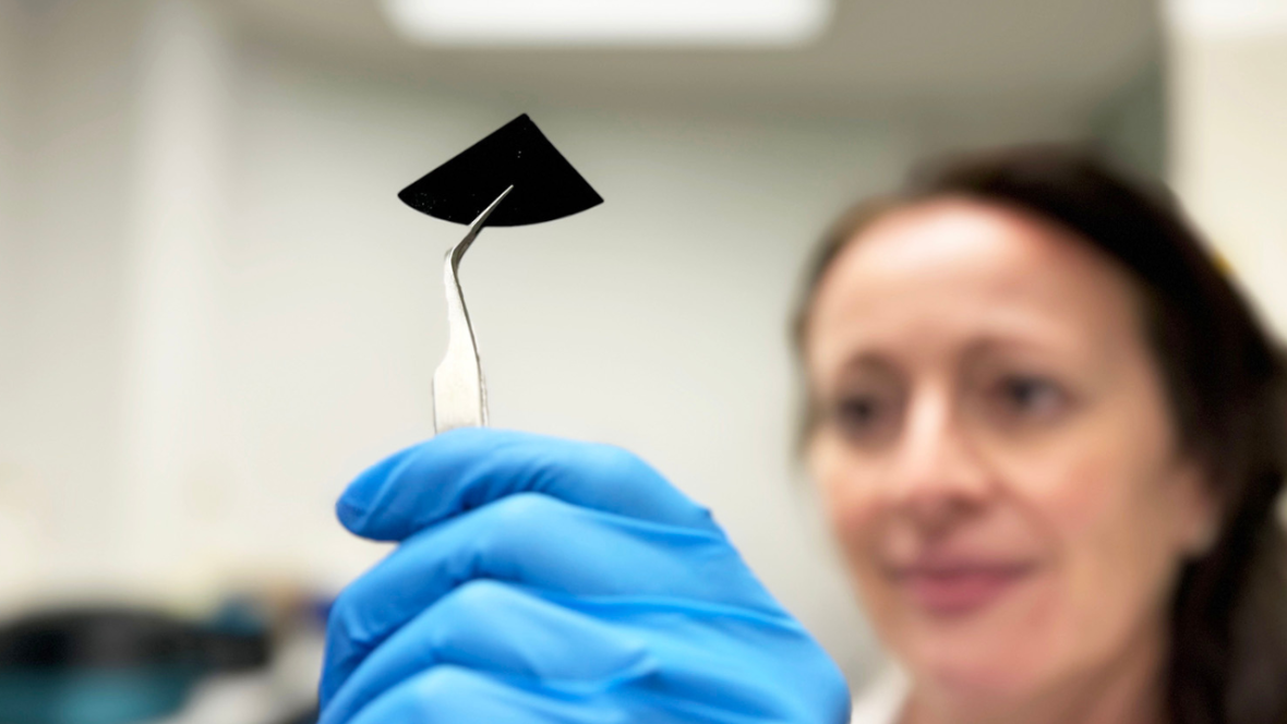 RMIT researcher Dr Natalie Borg inspects a sample of the nano-spiked silicon sheet.